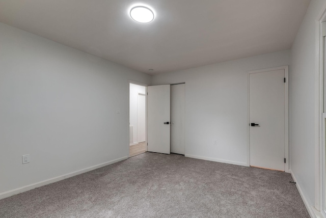 unfurnished room with light carpet