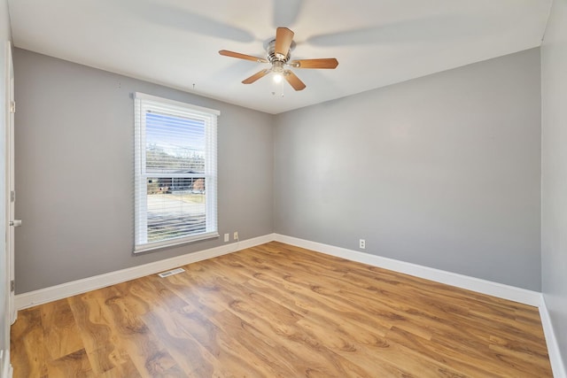 unfurnished room with ceiling fan and light wood-type flooring