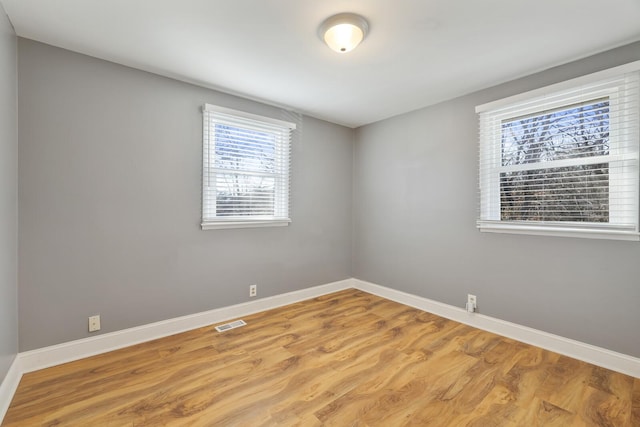 spare room with light hardwood / wood-style flooring