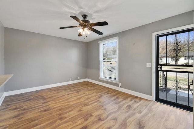 foyer entrance with light hardwood / wood-style floors and ceiling fan