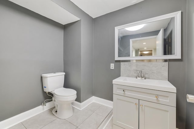 bathroom featuring tile patterned flooring, vanity, decorative backsplash, and toilet