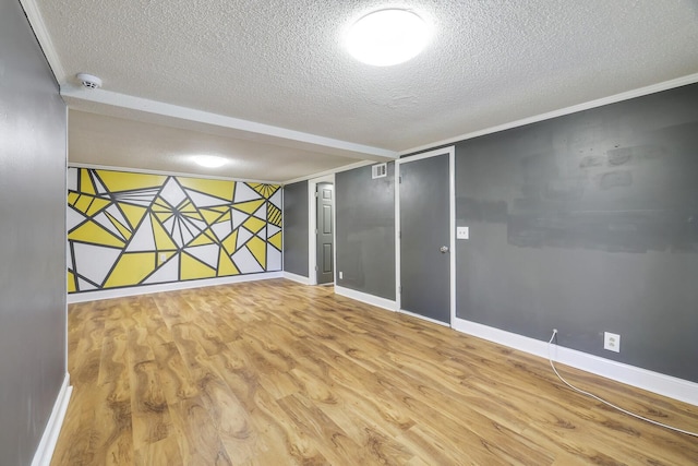 unfurnished room featuring a textured ceiling and light wood-type flooring