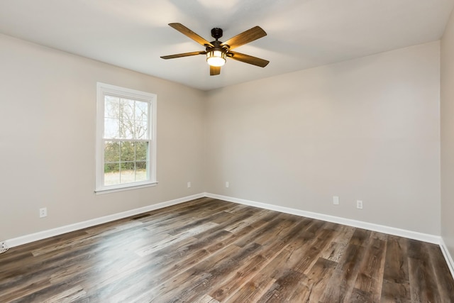 spare room featuring dark wood-type flooring and ceiling fan