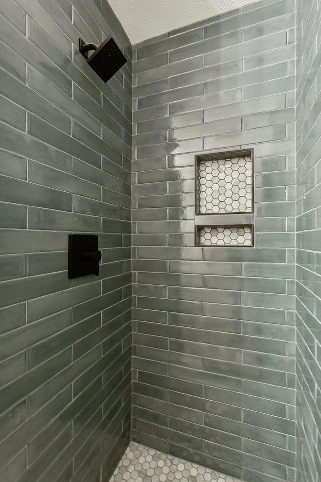 bathroom with a tile shower