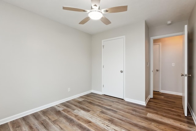 unfurnished bedroom featuring wood-type flooring and ceiling fan