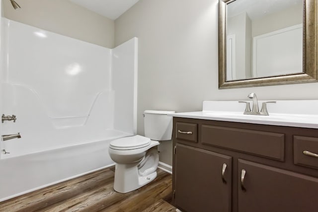 full bathroom with hardwood / wood-style flooring, shower / tub combination, vanity, and toilet