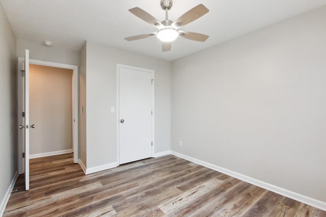 unfurnished bedroom featuring hardwood / wood-style floors and ceiling fan