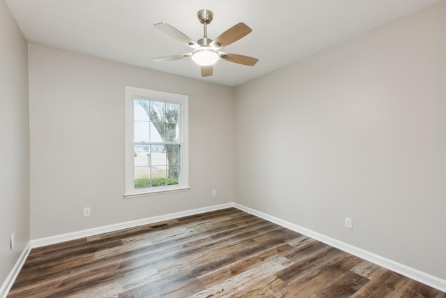 empty room featuring dark hardwood / wood-style floors and ceiling fan