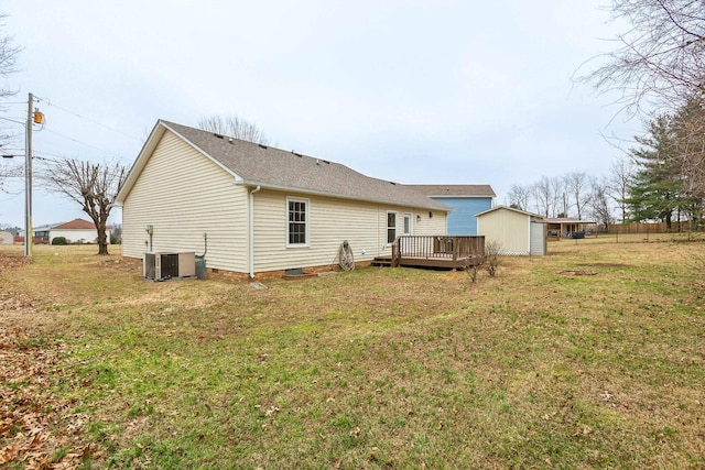 rear view of property featuring a wooden deck, a yard, and central air condition unit