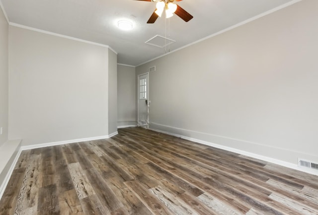 empty room with dark hardwood / wood-style flooring and crown molding