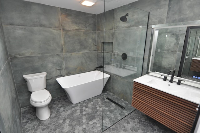 full bathroom with vanity, separate shower and tub, tile walls, and toilet