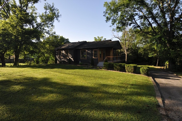 single story home featuring a front yard and a porch