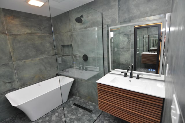 bathroom with vanity, tile walls, and plus walk in shower