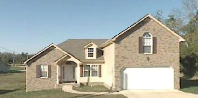 view of front of home featuring a garage and a front lawn