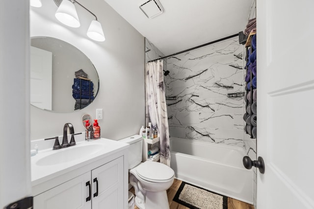 full bathroom with vanity, hardwood / wood-style floors, shower / tub combo, and toilet