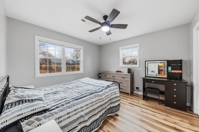 bedroom with multiple windows, ceiling fan, and light wood-type flooring