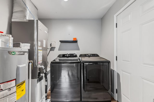 laundry area with washer and clothes dryer and electric water heater