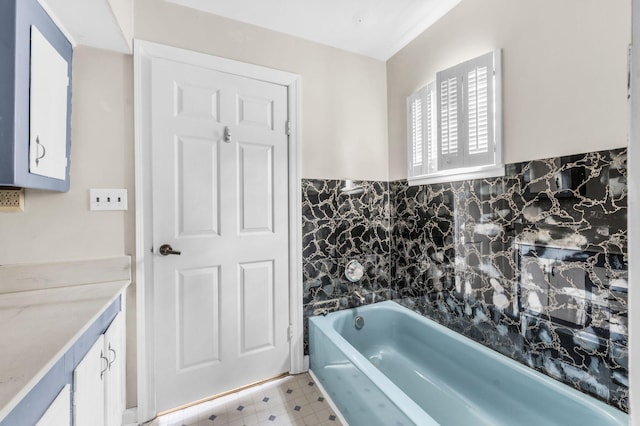 bathroom with vanity and a bath