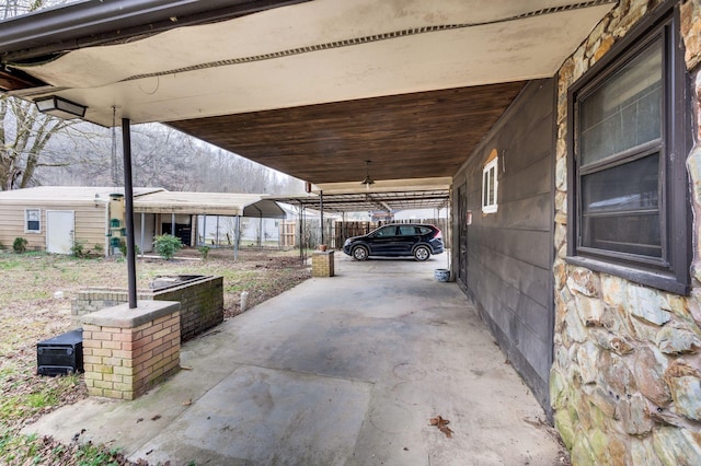 view of patio / terrace featuring a carport and a shed