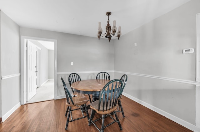 dining room featuring hardwood / wood-style floors and a notable chandelier