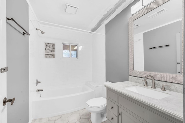 full bathroom with vanity, toilet, tiled shower / bath combo, and tile patterned flooring