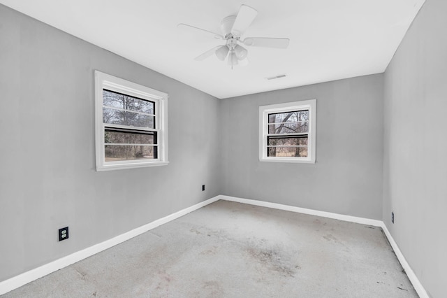 carpeted empty room featuring ceiling fan and a healthy amount of sunlight