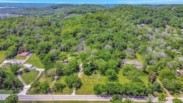 drone / aerial view featuring a wooded view