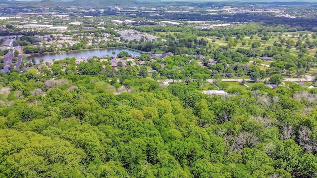 drone / aerial view featuring a forest view and a water view