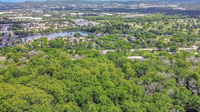 birds eye view of property featuring a water view and a view of trees