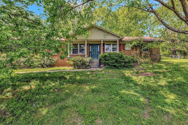 ranch-style house with a front lawn and brick siding