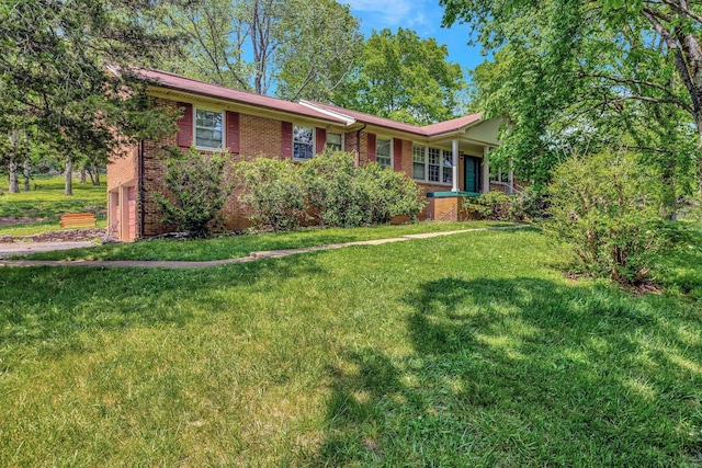 ranch-style home with an attached garage, a front lawn, and brick siding