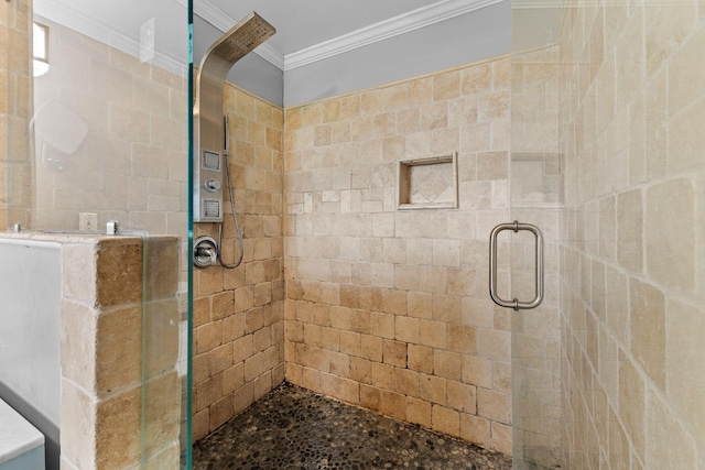 bathroom with a stall shower and ornamental molding