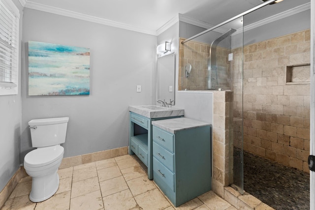 full bath featuring a stall shower, toilet, baseboards, vanity, and crown molding