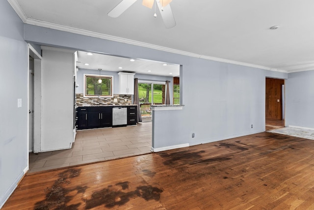 interior space featuring stainless steel dishwasher, ornamental molding, a ceiling fan, and light wood-style floors