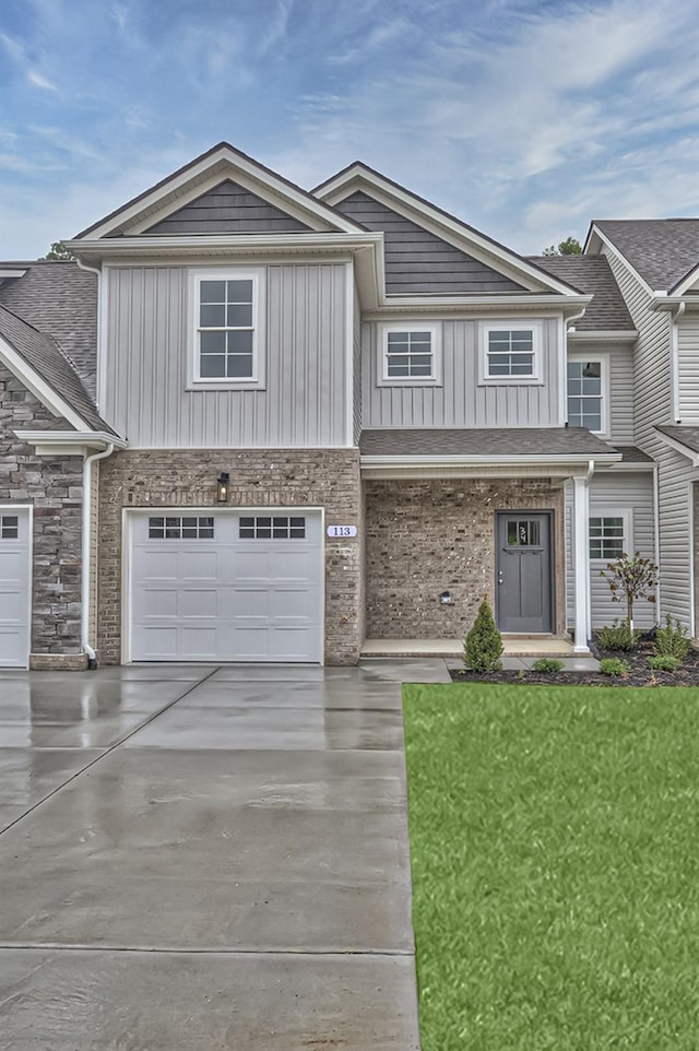 view of front of house featuring a garage and a front lawn