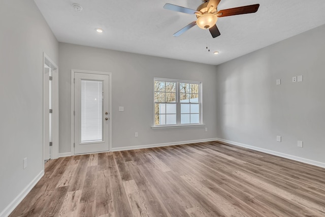 unfurnished room featuring recessed lighting, baseboards, ceiling fan, and light wood finished floors