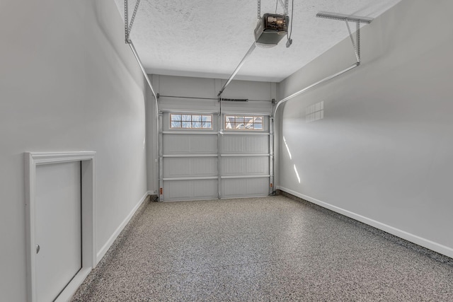 garage featuring baseboards and a garage door opener