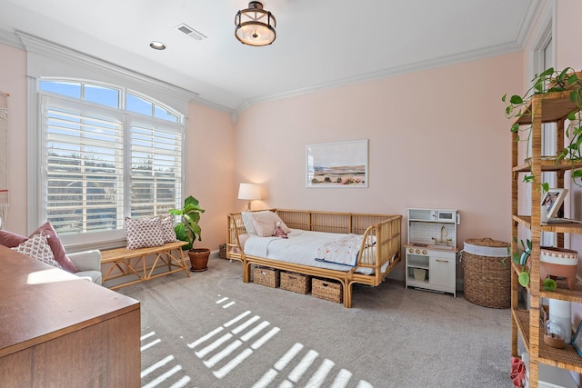 bedroom with ornamental molding and carpet flooring