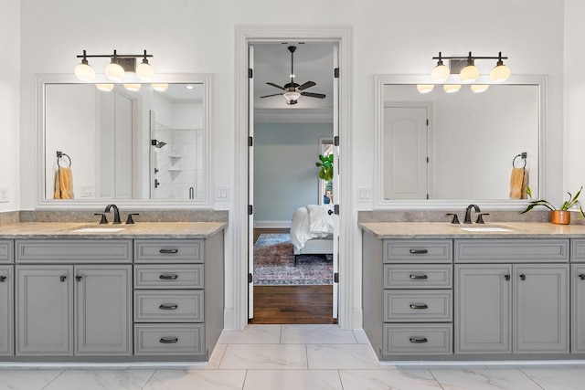 bathroom featuring vanity, ceiling fan, crown molding, and a shower