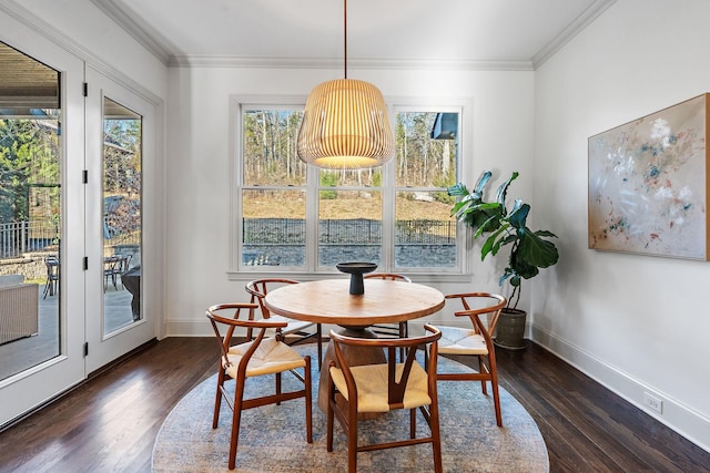 dining room with ornamental molding and dark hardwood / wood-style floors