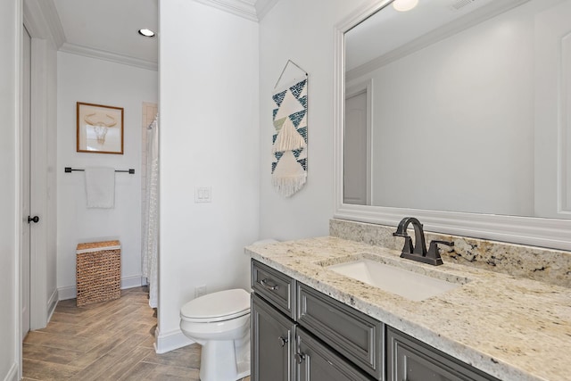 bathroom featuring parquet floors, ornamental molding, toilet, and vanity