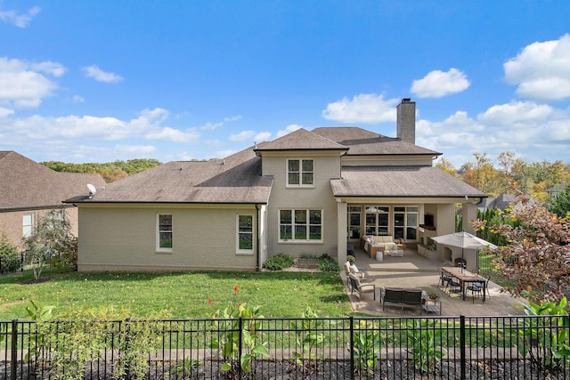 rear view of house with a patio, an outdoor hangout area, and a lawn