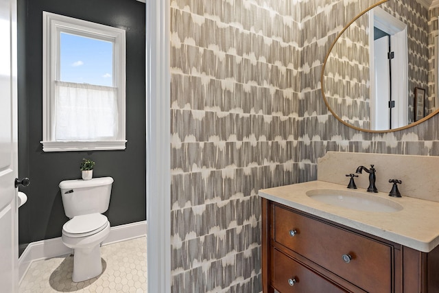 bathroom with vanity, tile patterned flooring, and toilet