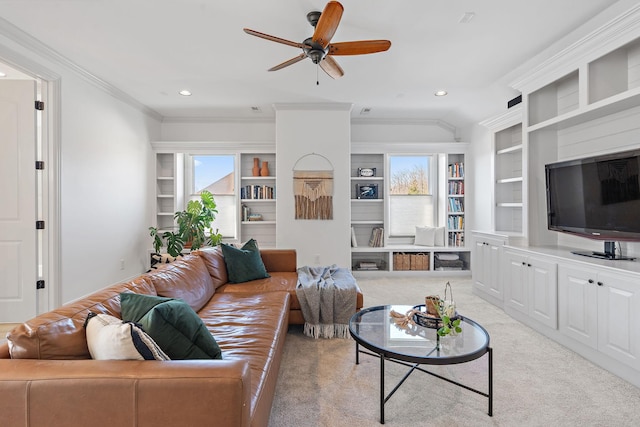 living room featuring built in features, a healthy amount of sunlight, and light carpet