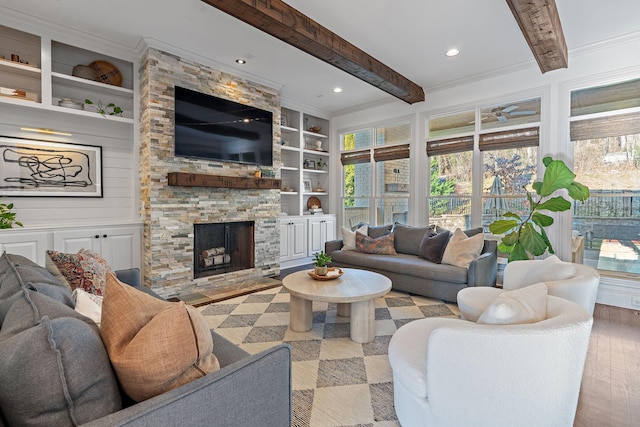 living room featuring a fireplace, beam ceiling, hardwood / wood-style floors, and built in features