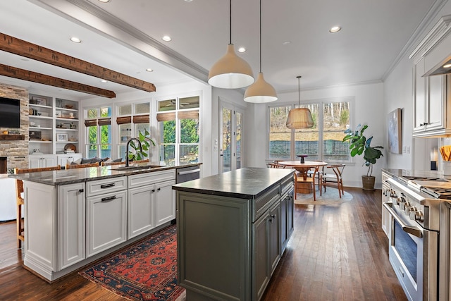 kitchen with white cabinetry, sink, an island with sink, and appliances with stainless steel finishes