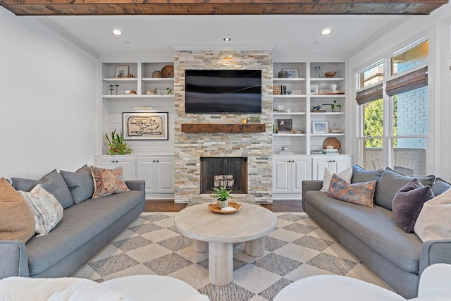 living room featuring a stone fireplace, built in features, and light wood-type flooring