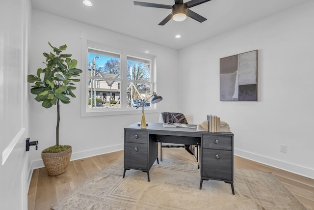 office space with ceiling fan and light wood-type flooring