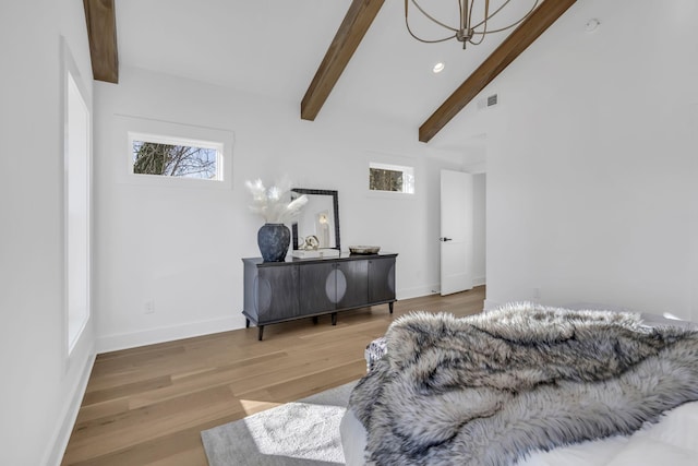 bedroom with hardwood / wood-style floors and vaulted ceiling with beams