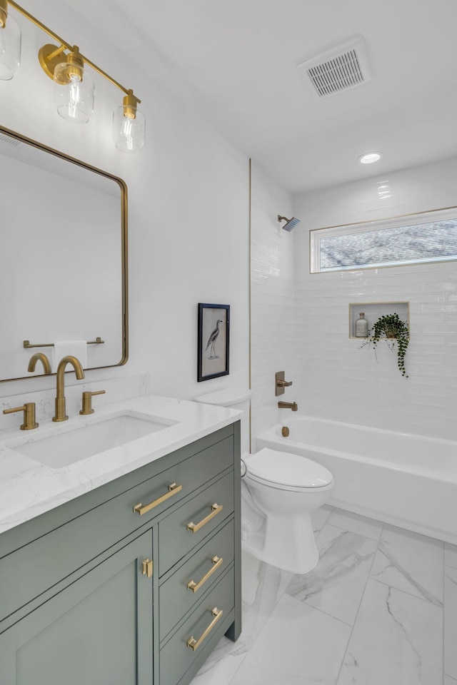 full bathroom with vanity, tiled shower / bath combo, and toilet